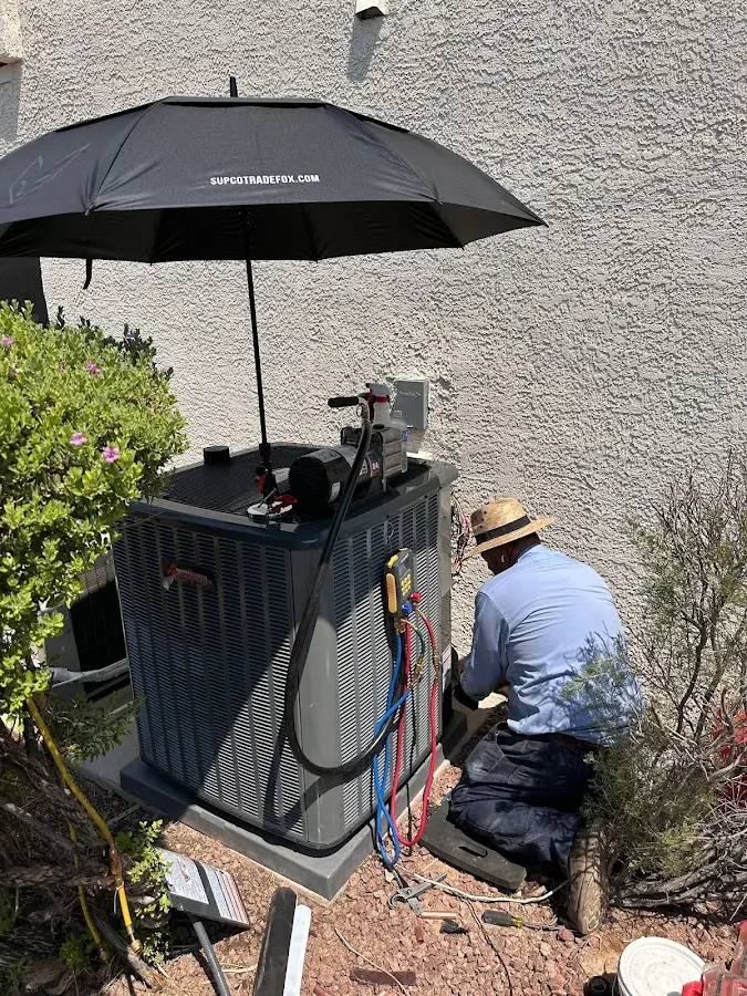 HVAC technician performing outdoor AC maintenance in Madison